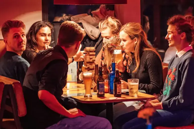Bezoekers aan tafel in de TonTon Club in Amsterdam